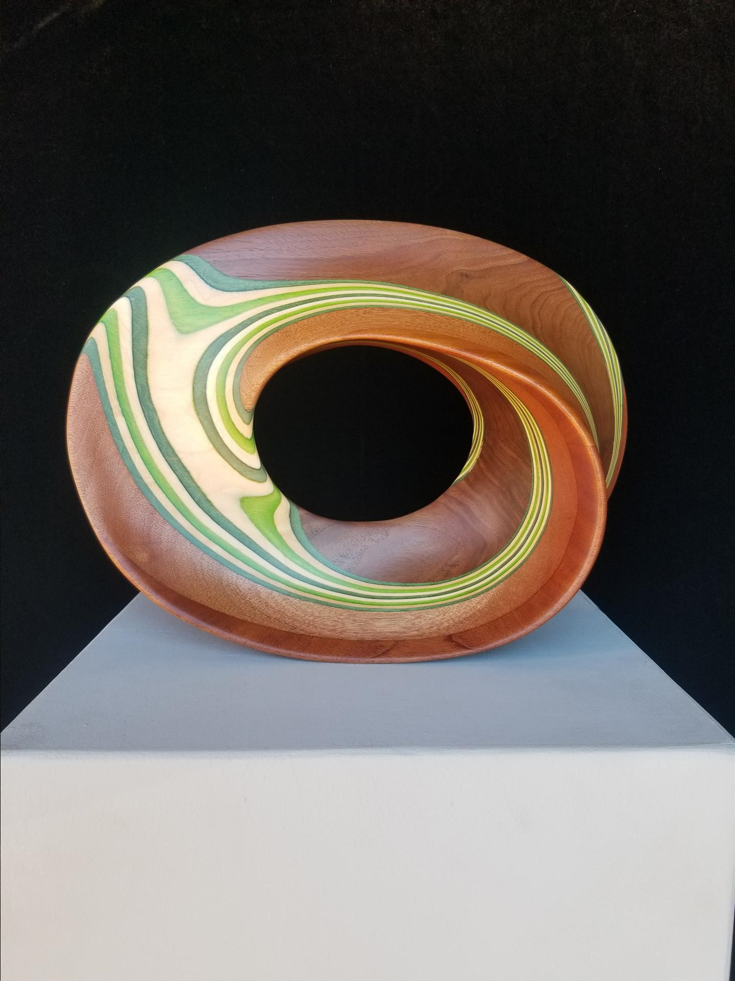 Steve Lawrence, Green Mobius. Wood sculpture, walnut, mahogany, and color dyed maple, 11x15x5.