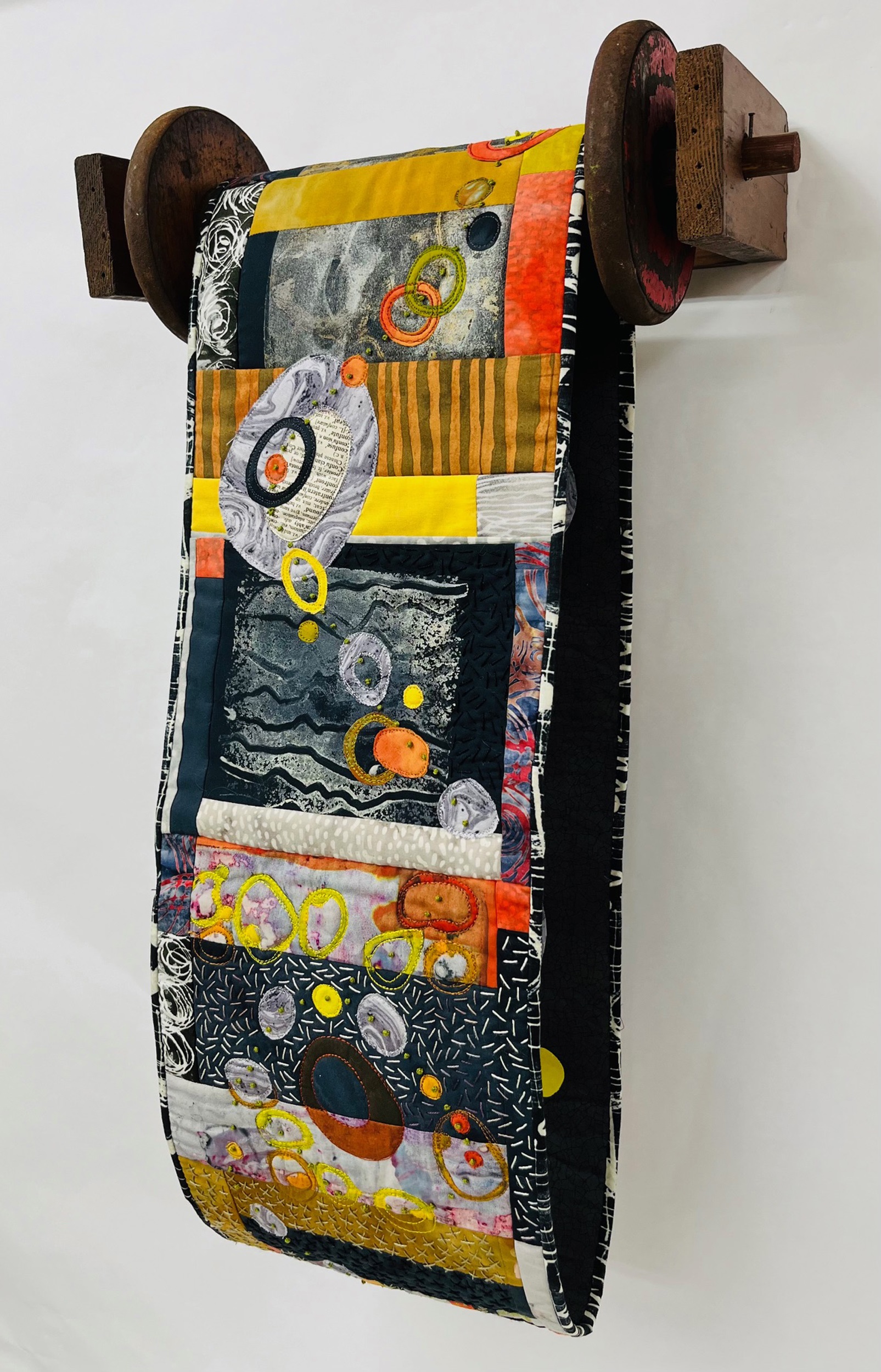 Charlotte Bird, Indecision, 2023. Hand cut fused appliqué, machine stitched, machine quilted, hand embroidered, vintage pine, vintage textile spool, hand colored dowel, 24” x 15” x 8”.
