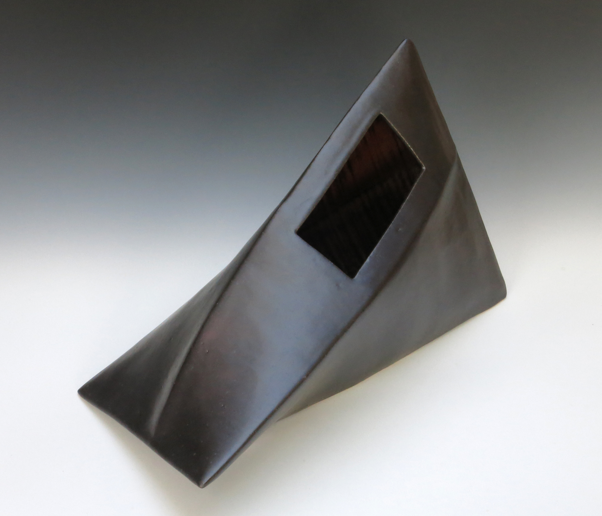 Ellen Fager, Black Container, 2023. Stoneware, thrown, assembled, and paddled, satin black glaze, 16” x 8” x 10”.