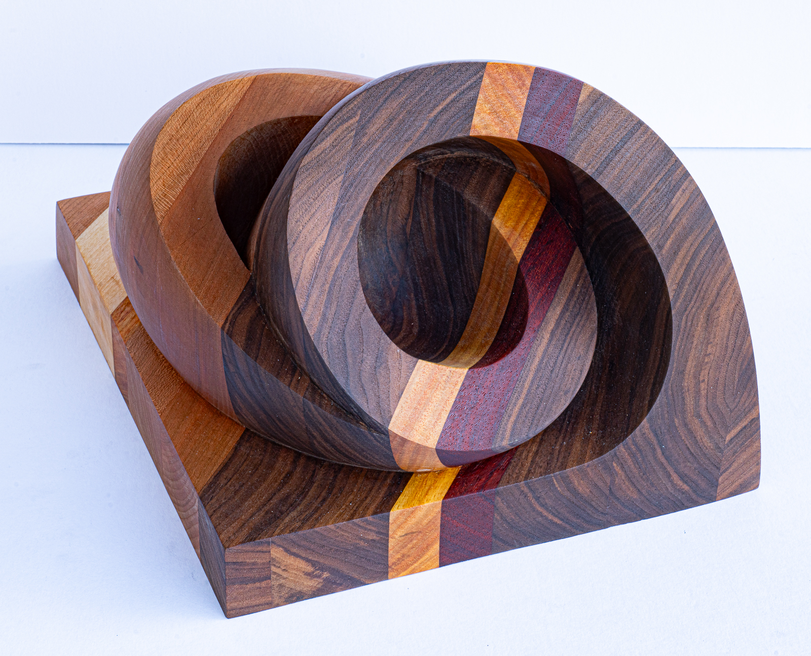 Ross  Stockwell, Coupled Forms, 2023. Wood (walnut, padouk, canary, cherry, bass), 11” x 13” x 9.5”.