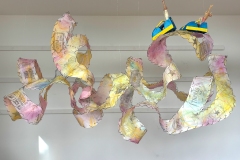 Birdy Harrison, Joy Ride, 2026. Encaustic monotype, wire, and paper clay, 26" x 44" x 26".