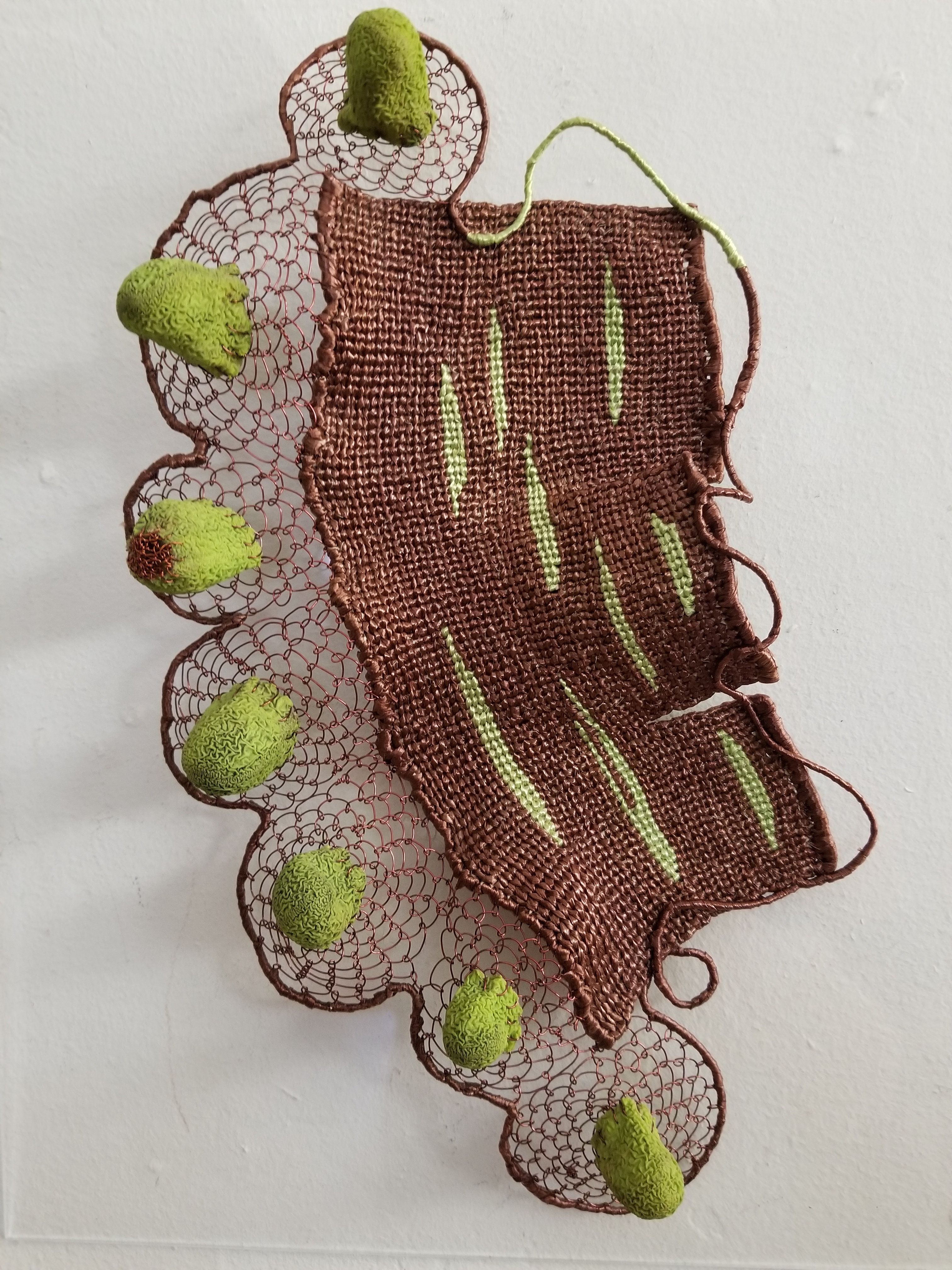 Polly Giacchina, Counting on Your Fingers. Vintage raffia and discarded garden gloves mounted on plexi glass, 14" x 11" x 1".