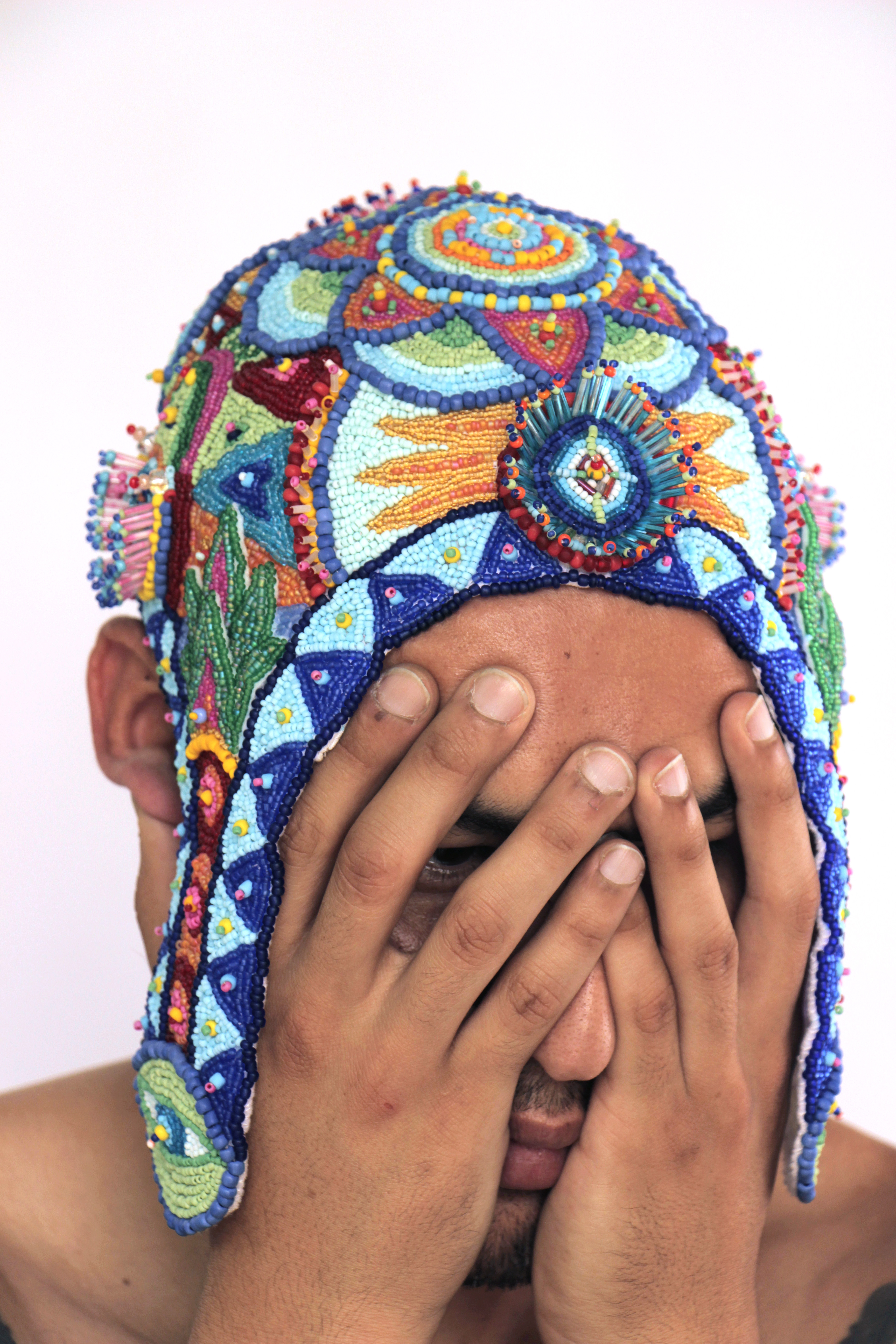 Isa Guadalupe, Aurora del Pensamiento (detail), 2023.  Hand-beaded headpiece with glass beads on cotton and felt. Modeled by Andrés García. Photography by Socrates Medina, 2023.